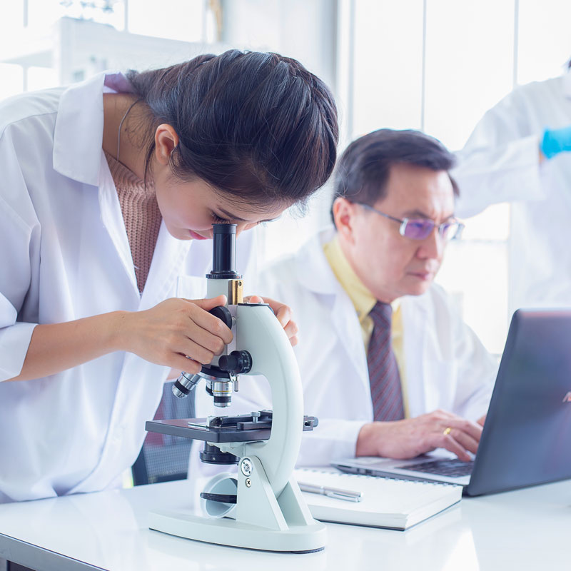 health professional using microscope